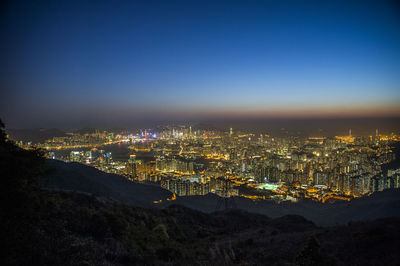 High angle view of illuminated city against sky at night