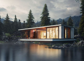 Modern house surrounded by trees by a lake at sunset. image created by artificial intelligence and later modified