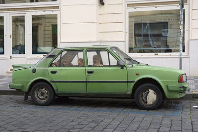 Vintage car on street against building