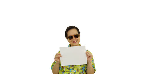 Portrait of a smiling young man using smart phone against white background