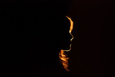 Silhouette woman against black background