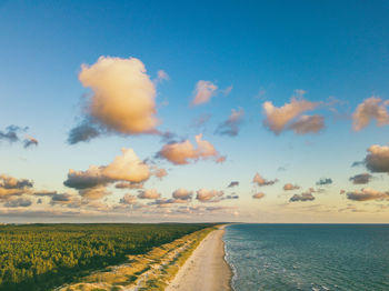 Scenic view of road by sea against sky