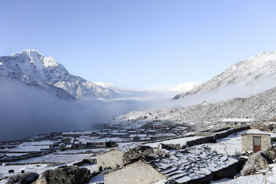 Houses with snowcapped mountain in background