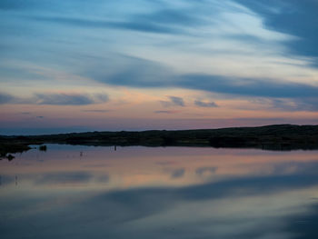 Scenic view of lake against sky during sunset