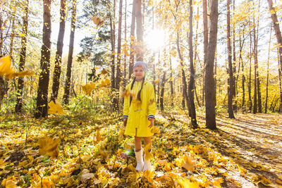 Woman standing in forest during autumn