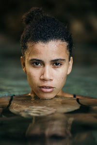 Close-up portrait of young woman swimming in sea