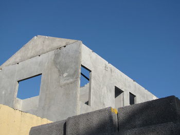 Low angle view of building against clear blue sky