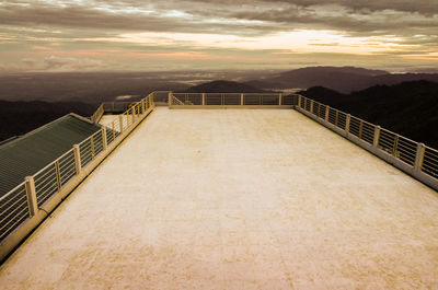 High angle view of empty terrace against cloudy sky