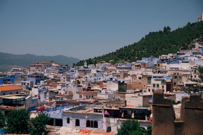 Buildings in town against clear sky