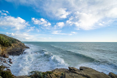 Mediterranean coast with waves and cloudy sky