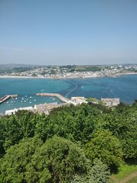 High angle view of sea and trees against sky