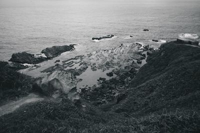 High angle view of rocks in sea against sky