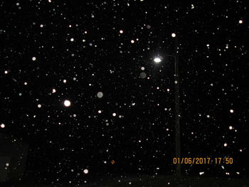 Illuminated lights against sky at night