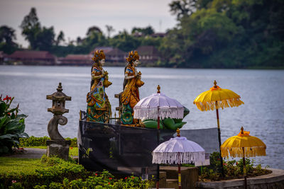 Umbrellas growing in temple against sky