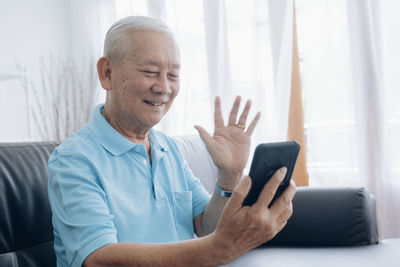 Midsection of man using mobile phone