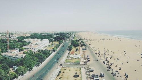 High angle view of city by sea against clear sky