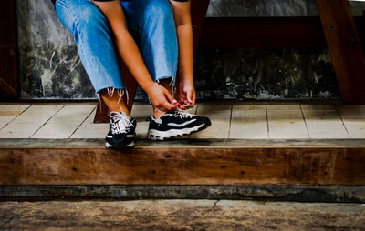 Low section of women sitting on floor