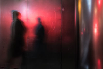 Shadow of people on glass wall