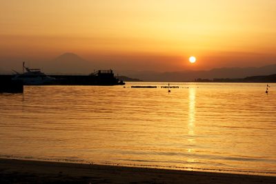 Scenic view of sea against orange sky