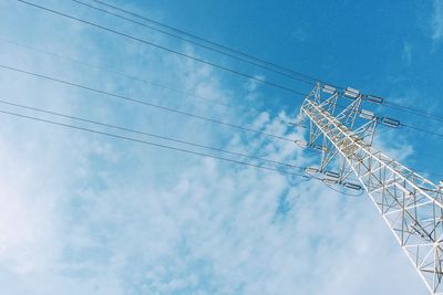 Low angle view of crane against blue sky