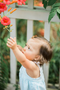 Close-up of cute baby girl with flowers