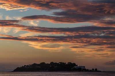 Scenic view of dramatic sky over sea during sunset