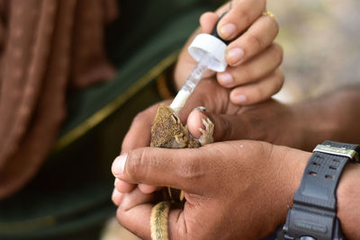 Close-up of hand holding syringe