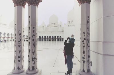 Full length of man standing outside temple