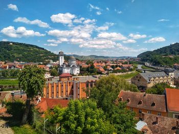 Buildings in town against sky