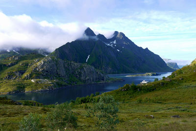 Scenic view of lake and mountains against sky