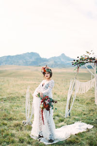 Rear view of woman standing on field