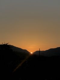 Scenic view of silhouette mountains against sky during sunset