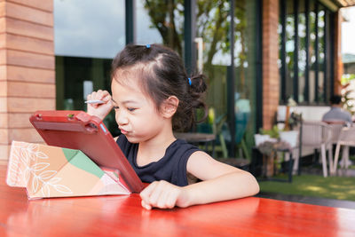 Portrait of young woman reading book