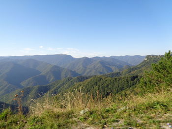 Scenic view of mountains against clear blue sky