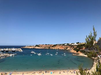 Scenic view of beach against clear blue sky