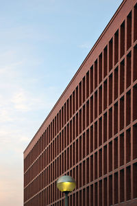 Brick building with repeating pattern at sunset