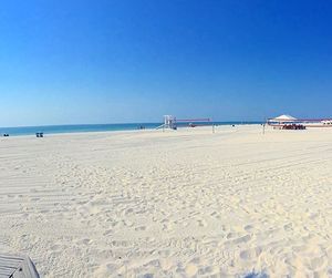 View of beach against clear blue sky