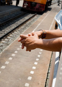 Close-up of person hand on railroad track