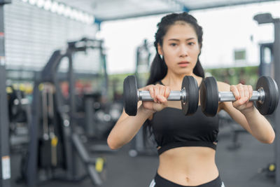 Young woman exercising at gym