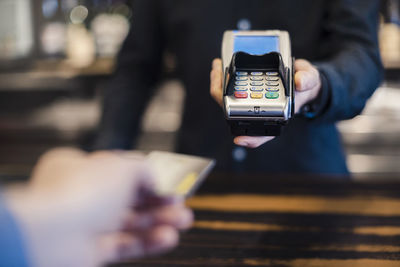 Man using credit card reader, close-up