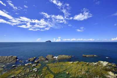 Scenic view of sea against blue sky