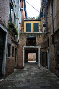 Empty alley amidst buildings in city