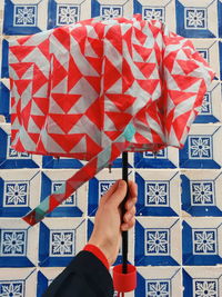 Low section of person holding red flag