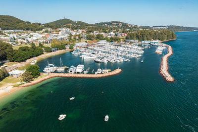 High angle view of sea and cityscape against sky