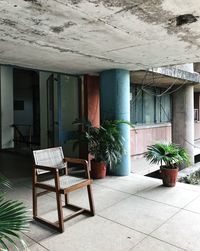 Empty chairs and tables against building