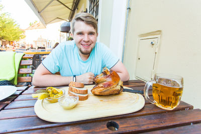 Portrait of a smiling man holding food