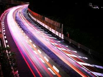 High angle view of light trails on highway at night