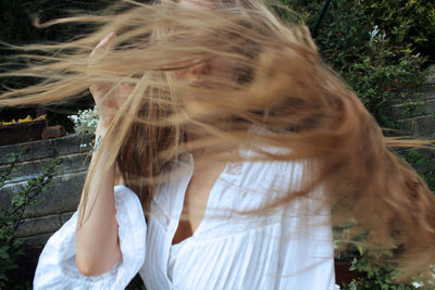 Portrait of woman tossing hair