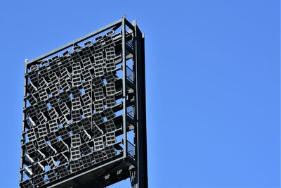 Low angle view of modern building against clear blue sky