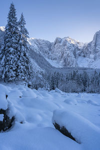 Scenic view of snow covered mountains against clear sky